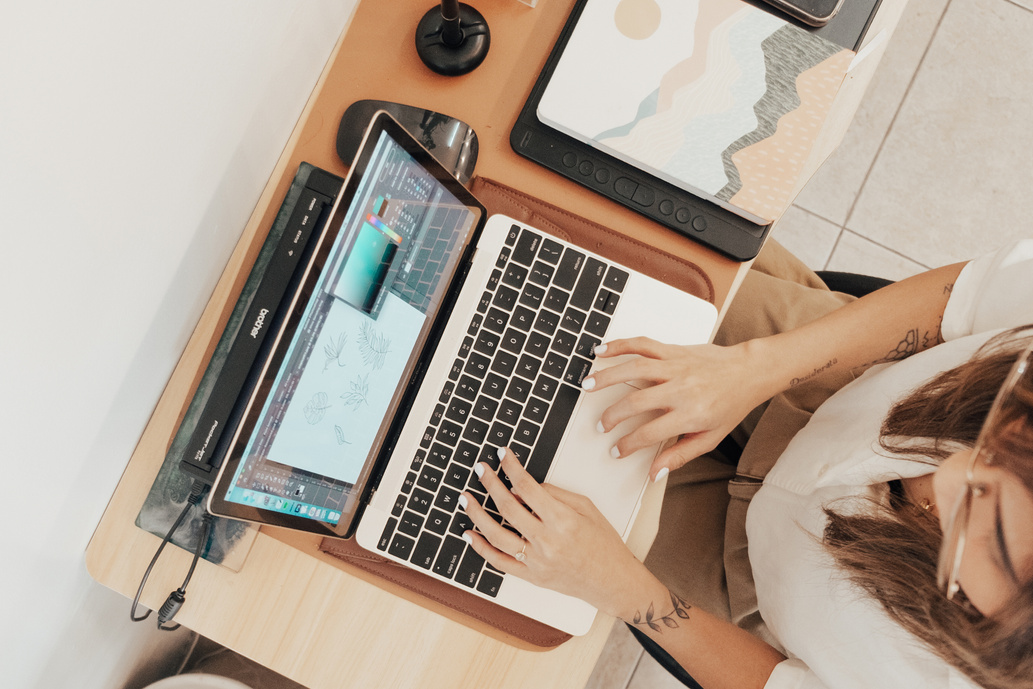Female Designer Working with Laptop in Studio